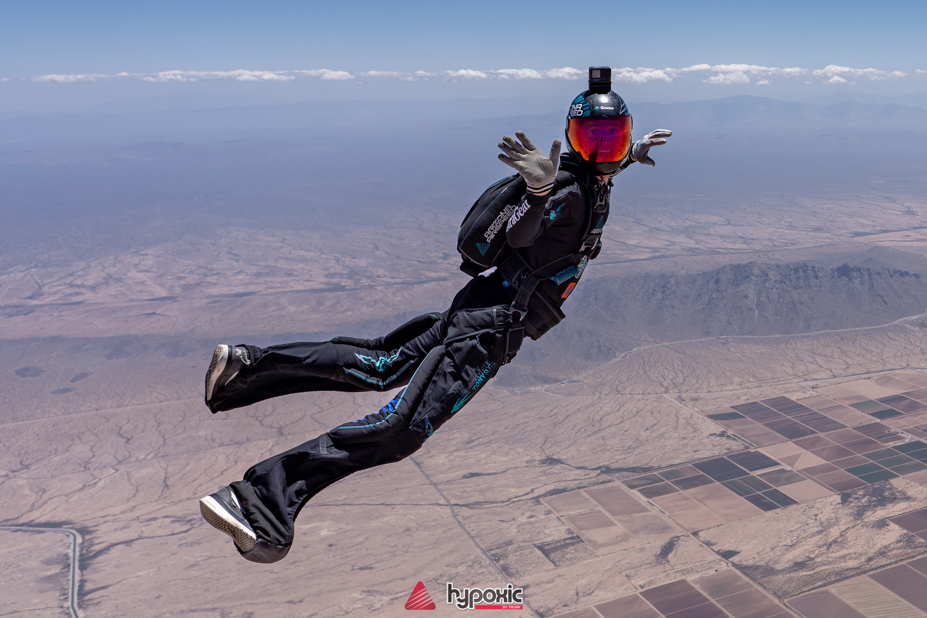A solo skydiver flying above the Arizona desert
