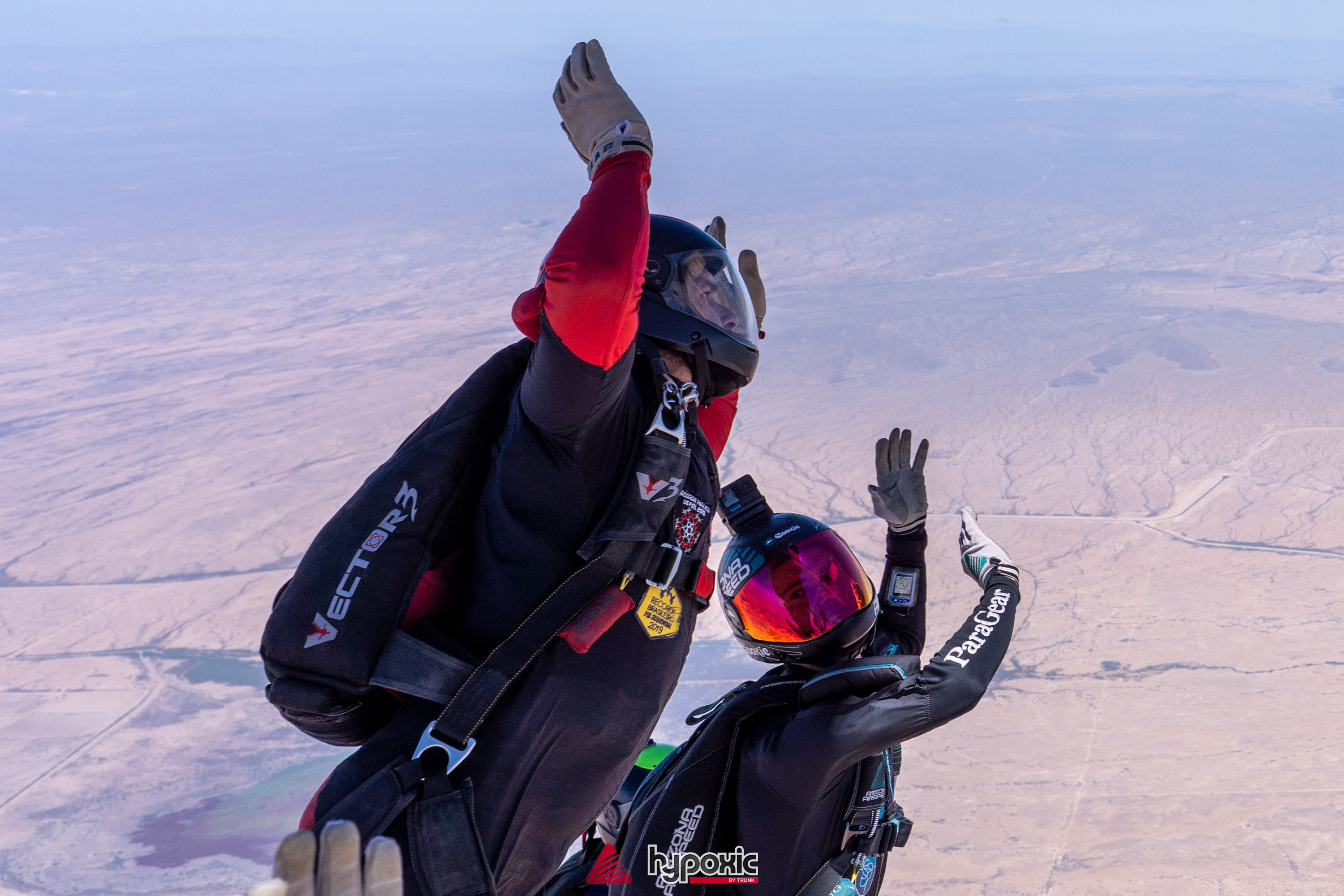 Two skydivers flying together in close formation