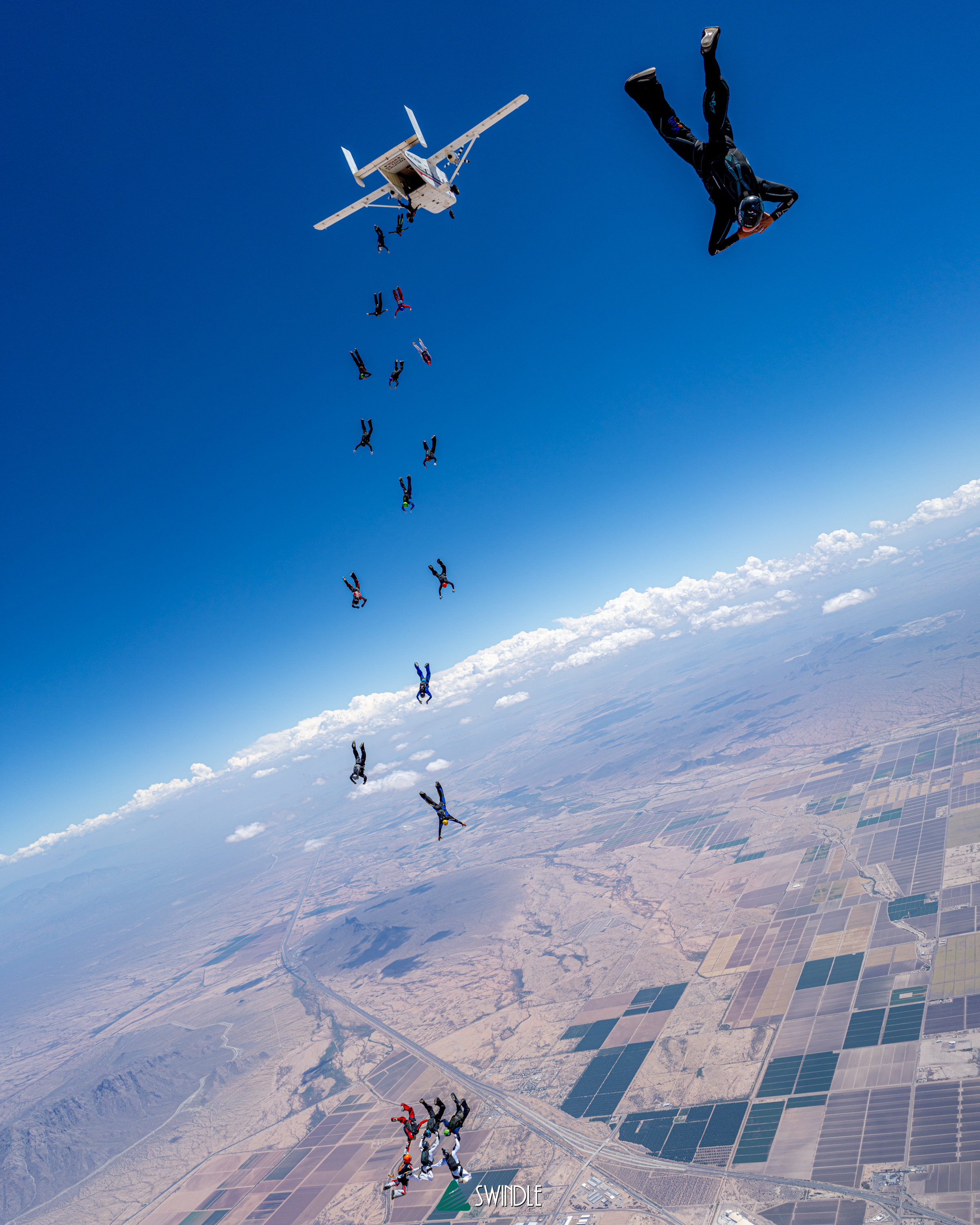 Skydivers descending from a jump plane above the desert