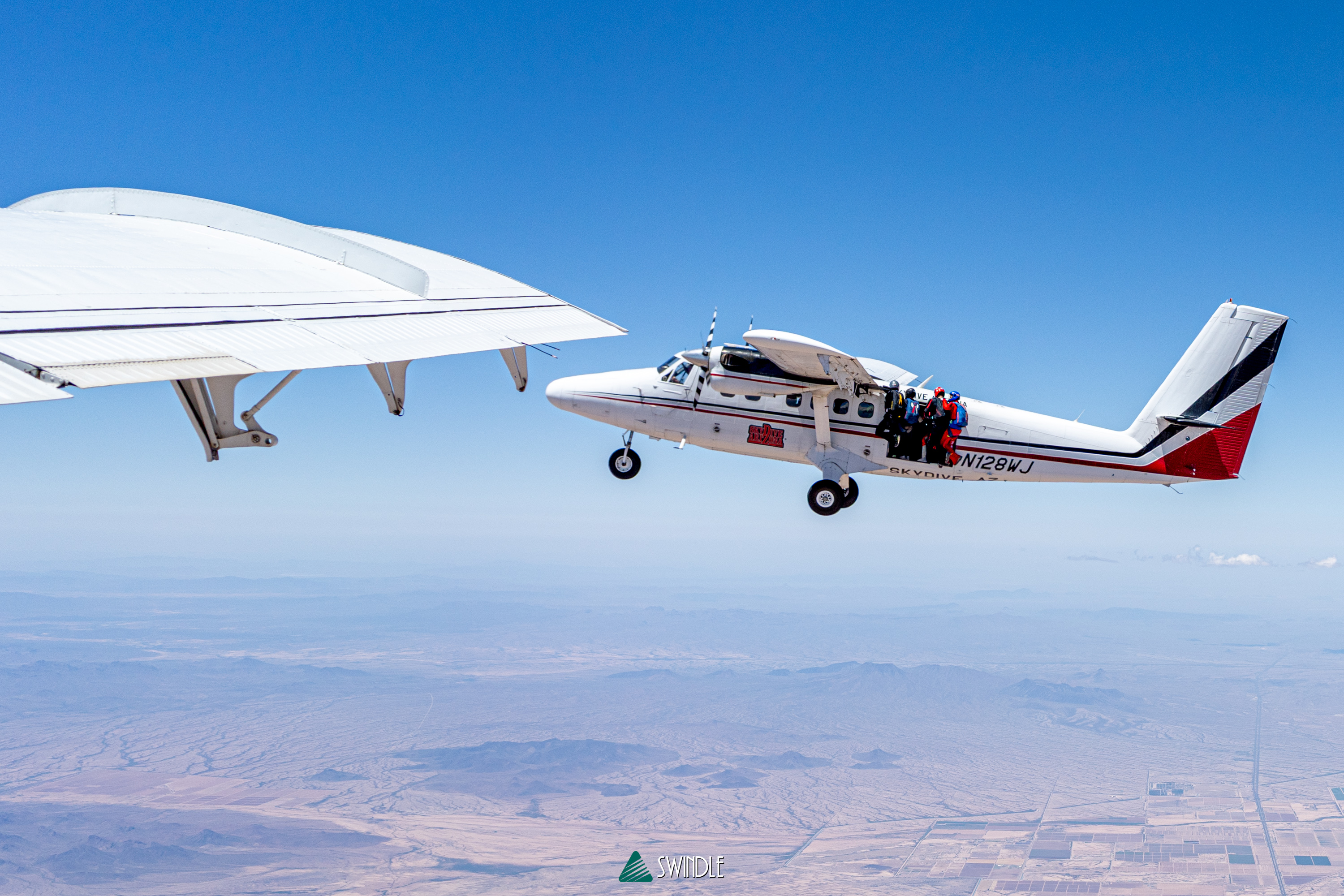 A jump plane flying above the Arizona landscape