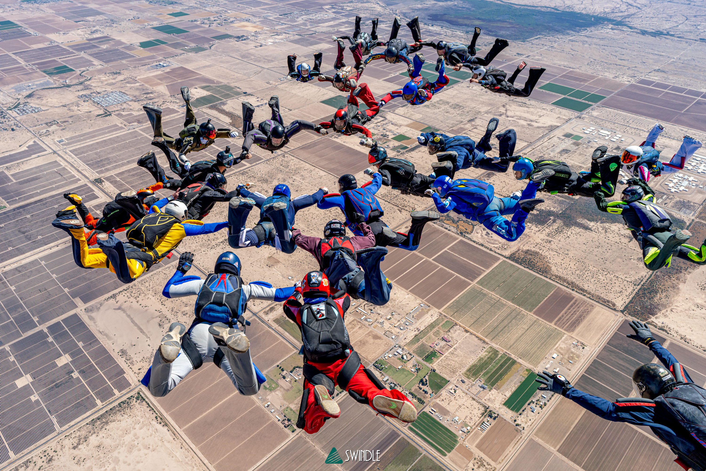Large skydiving formation over Arizona farmland